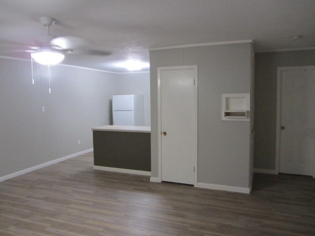 505 13th Street Huntsville, TX 77340 - Photo 11 of 12 a view of an empty room with wooden floor and a window