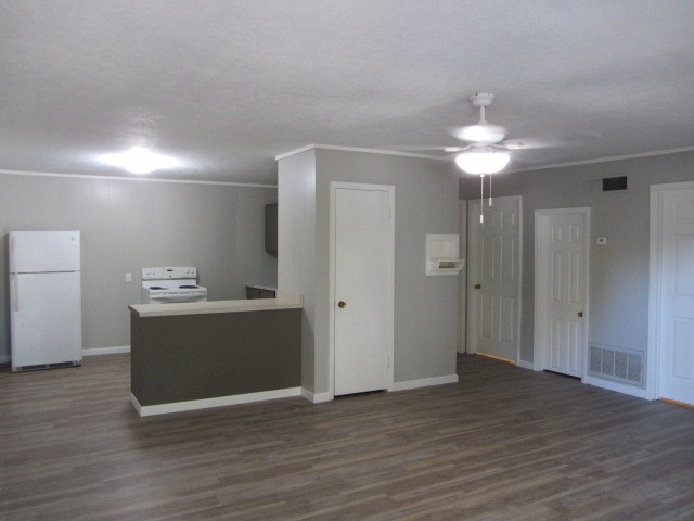 505 13th Street Huntsville, TX 77340 - Photo 3 of 12 a view of a kitchen with wooden floor and a ceiling fan