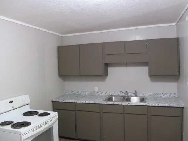 a kitchen with a refrigerator and a stove