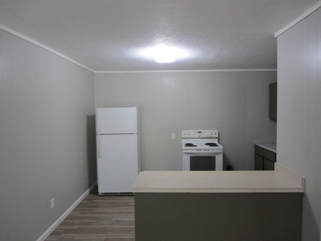 505 13th Street Huntsville, TX 77340 - Photo 5 of 12 a kitchen with a refrigerator and a stove