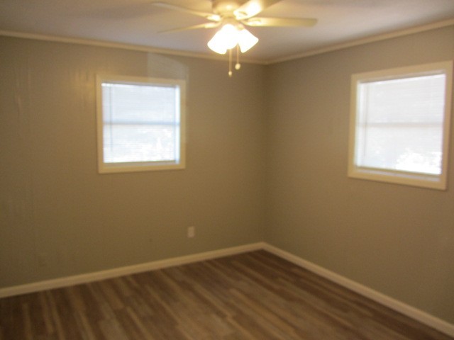 505 13th Street Huntsville, TX 77340 - Photo 7 of 12 a view of an empty room with wooden floor and a window