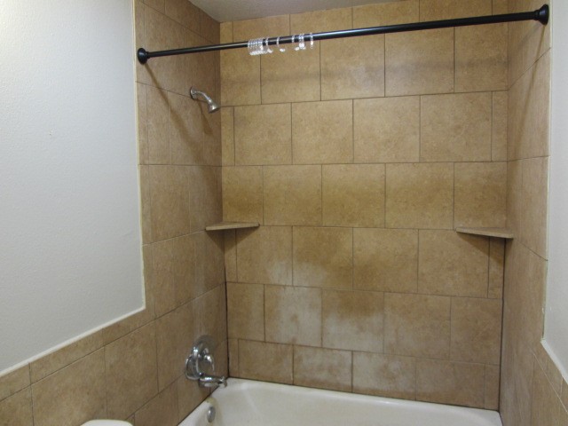 505 13th Street Huntsville, TX 77340 - Photo 9 of 12 a bathroom with a shower