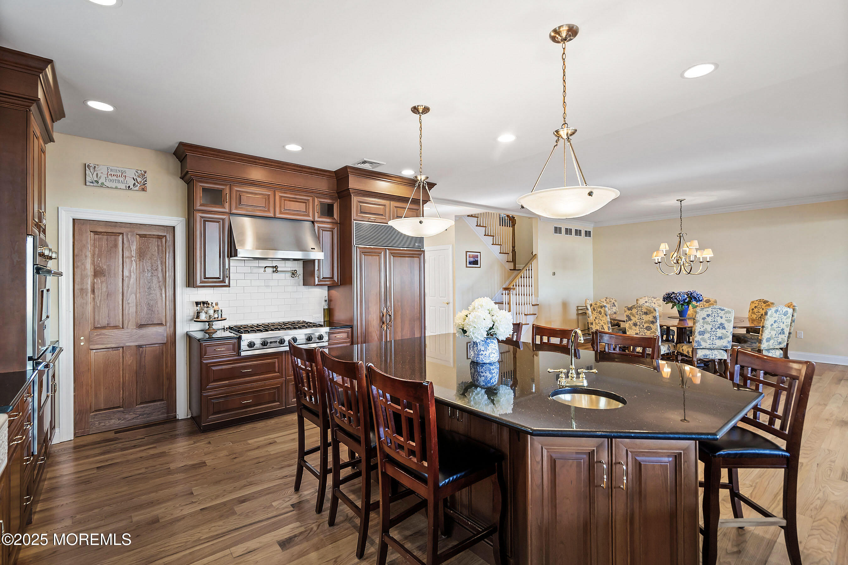 38 Ocean Avenue Manasquan, NJ 08736 - Photo 12 of 42 a kitchen with stainless steel appliances a dining table chairs stove and refrigerator