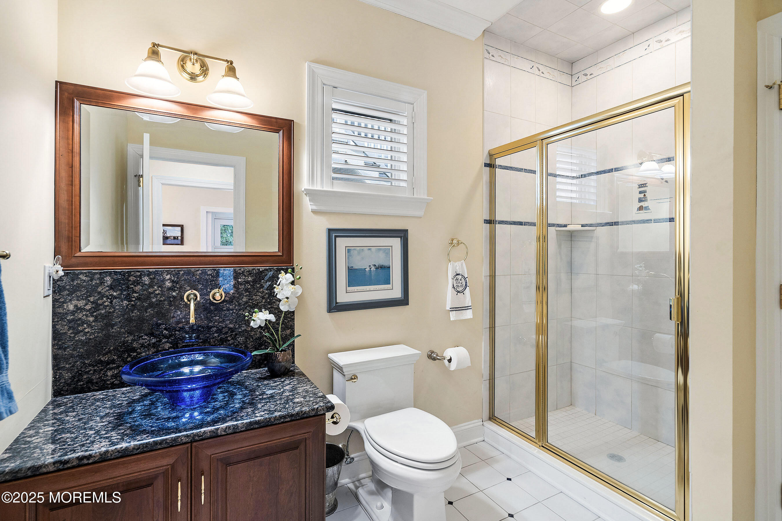 38 Ocean Avenue Manasquan, NJ 08736 - Photo 13 of 42 a bathroom with a toilet a sink and glass door