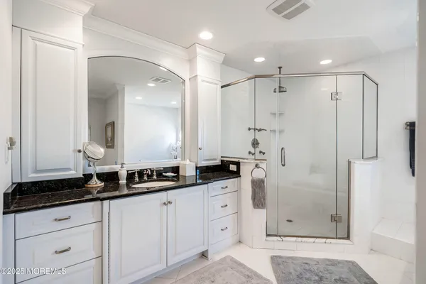 a bathroom with double sink and a mirror