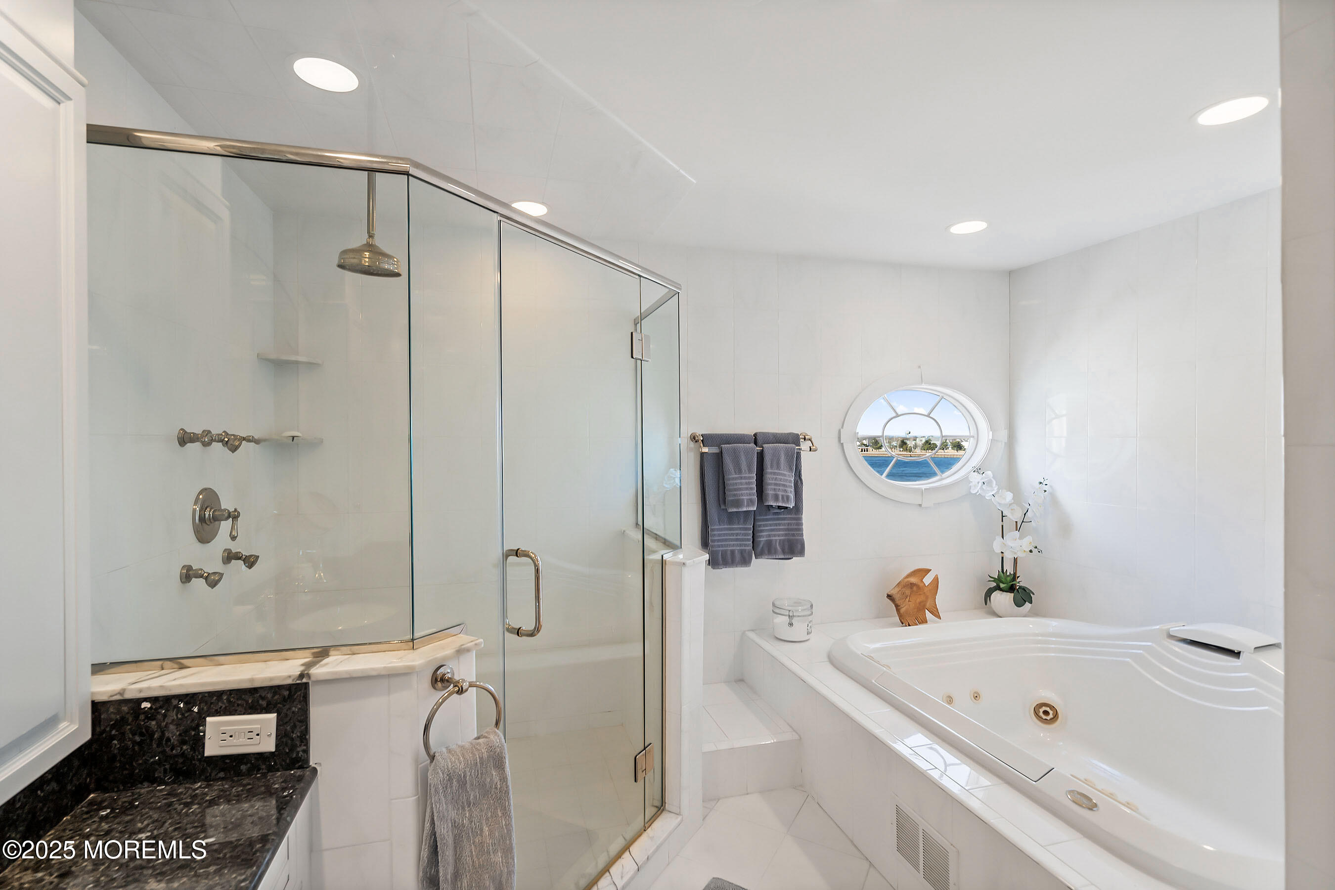 38 Ocean Avenue Manasquan, NJ 08736 - Photo 18 of 42 a bathroom with a tub a sink and a shower