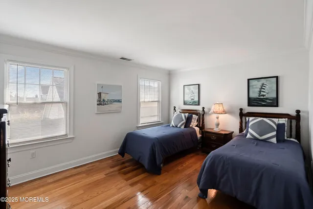 a bedroom with two beds and a window