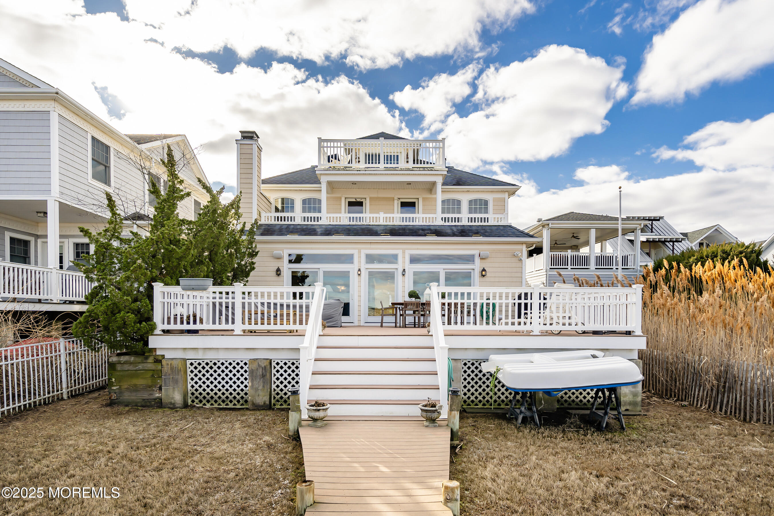 38 Ocean Avenue Manasquan, NJ 08736 - Photo 2 of 42 a view of a white building among the yard and deck