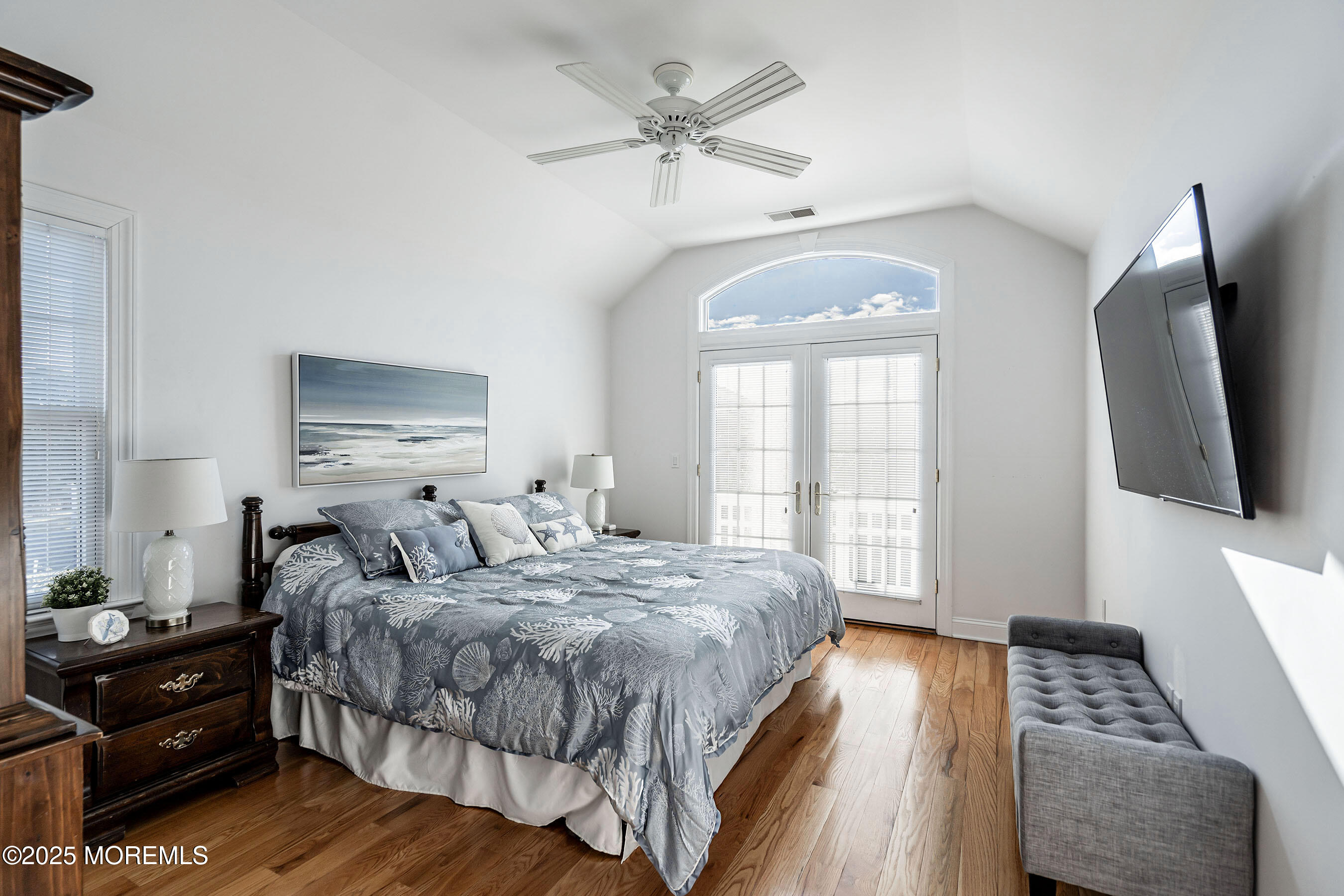 38 Ocean Avenue Manasquan, NJ 08736 - Photo 22 of 42 a bedroom with a bed window and a flat screen tv