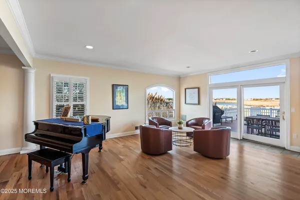 a living room with furniture a piano and a window