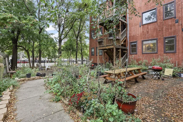 a view of a chairs and table in a backyard