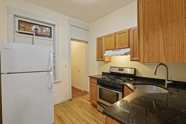 a kitchen with sink a refrigerator and a stove