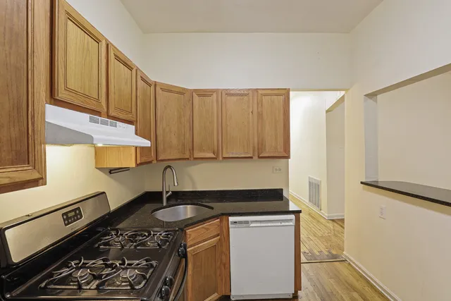 a kitchen with stainless steel appliances a stove a sink and a refrigerator
