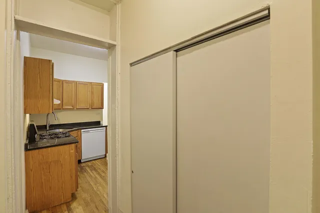 a kitchen with a refrigerator and a stove top oven
