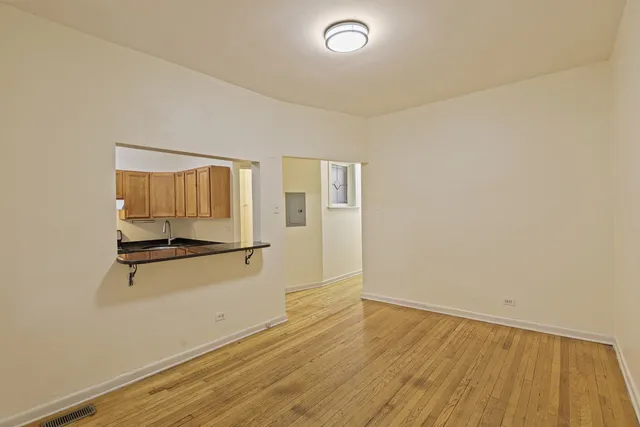 an empty room with wooden floor