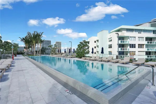 a view of swimming pool with outdoor seating and plants