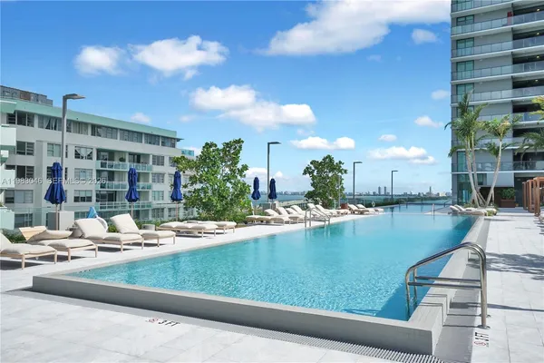 a view of a swimming pool with outdoor seating