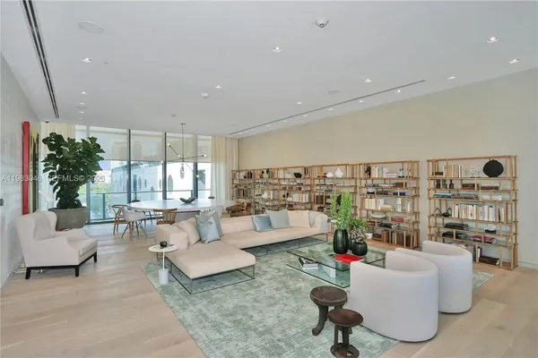 a living room with furniture and a book shelf