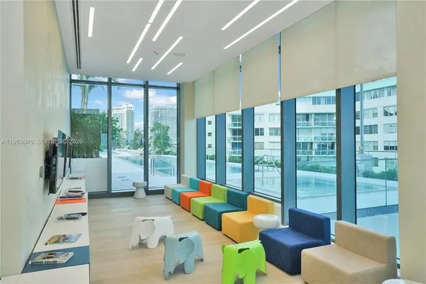 a balcony with furniture and a floor to ceiling window