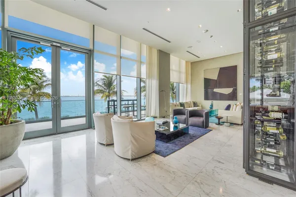 a living room with furniture and large windows