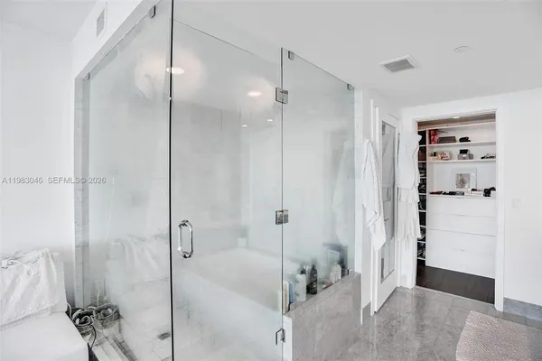 a bathroom with a bathtub and a shower