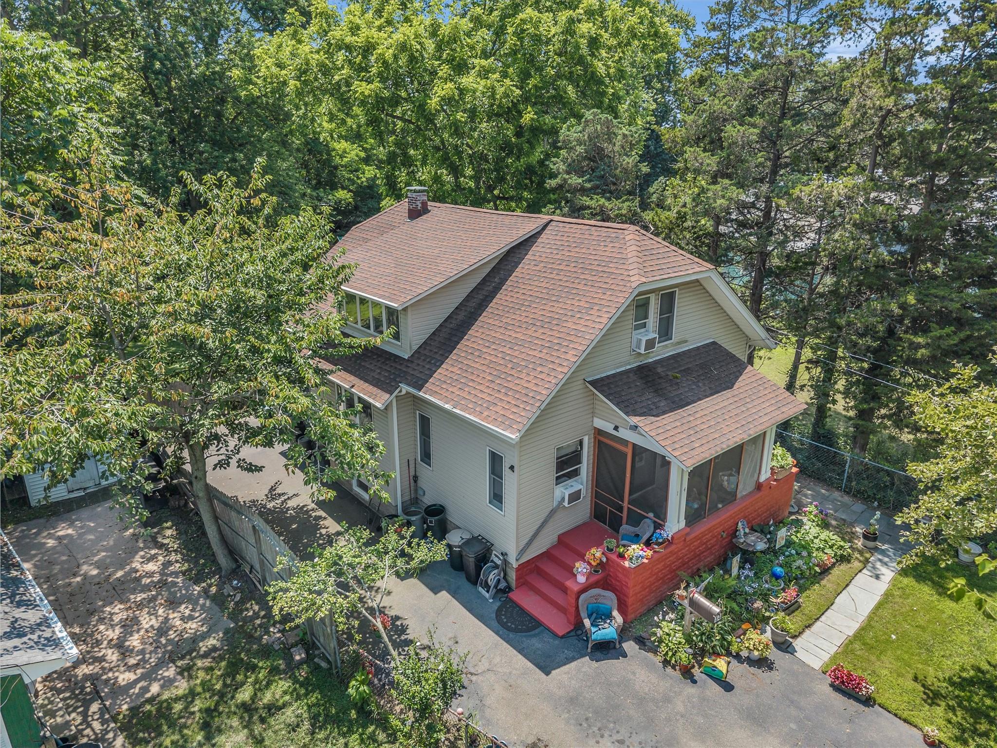an aerial view of a house with a yard table and chairs