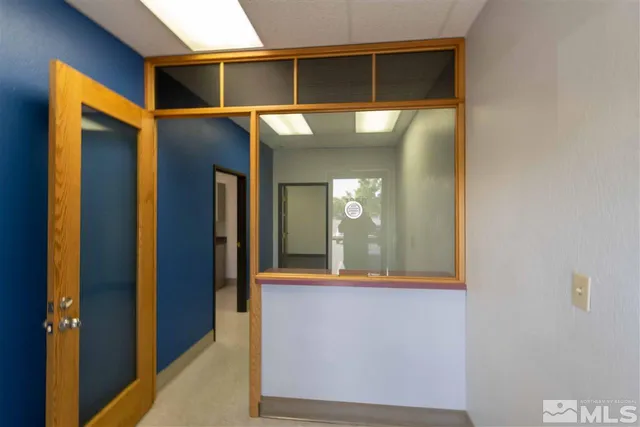a view of a hallway with wooden shelves