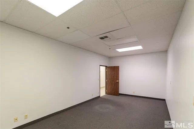a view of a hallway with wooden shelves