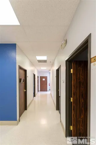 a view of a hallway with wooden shelves