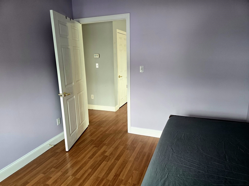 303 Eagle Street, Unit C Fall River, MA 02721 - Photo 20 of 32 a view of a hallway with wooden floor and staircase
