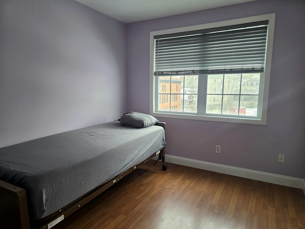 303 Eagle Street, Unit C Fall River, MA 02721 - Photo 21 of 32 a bedroom with a bed and a window