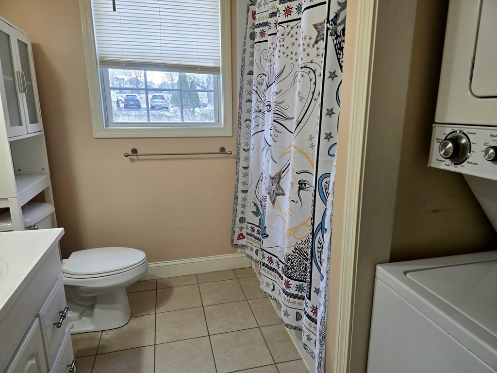 303 Eagle Street, Unit C Fall River, MA 02721 - Photo 24 of 32 a bathroom with a toilet and a shower curtain