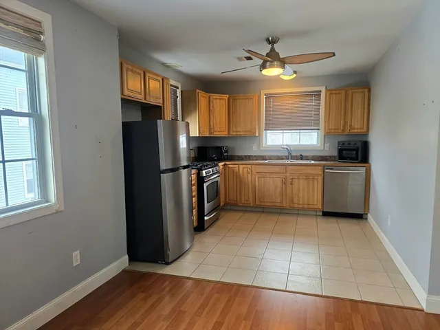 a kitchen with a refrigerator a stove a microwave and cabinets