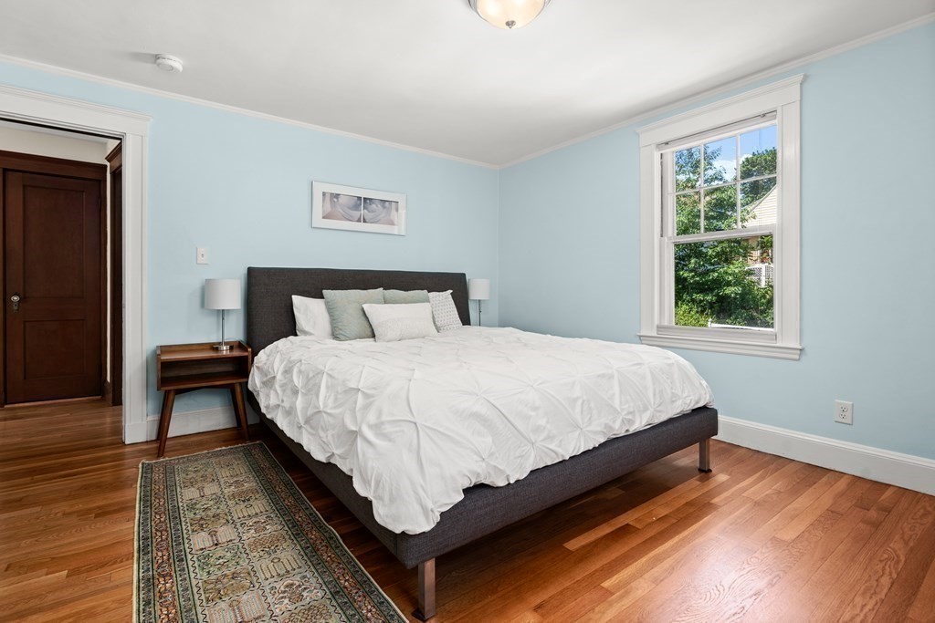 52 Arborough Road Boston, MA 02131 - Photo 11 of 35 a bed sitting in a bedroom next to a window