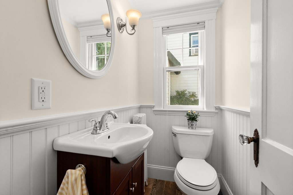 52 Arborough Road Boston, MA 02131 - Photo 18 of 35 a bathroom with a sink a toilet and mirror