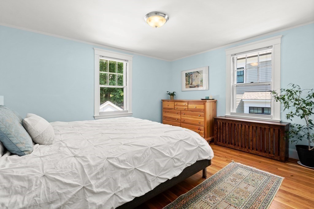 52 Arborough Road Boston, MA 02131 - Photo 26 of 35 a bedroom with a bed and wooden floor