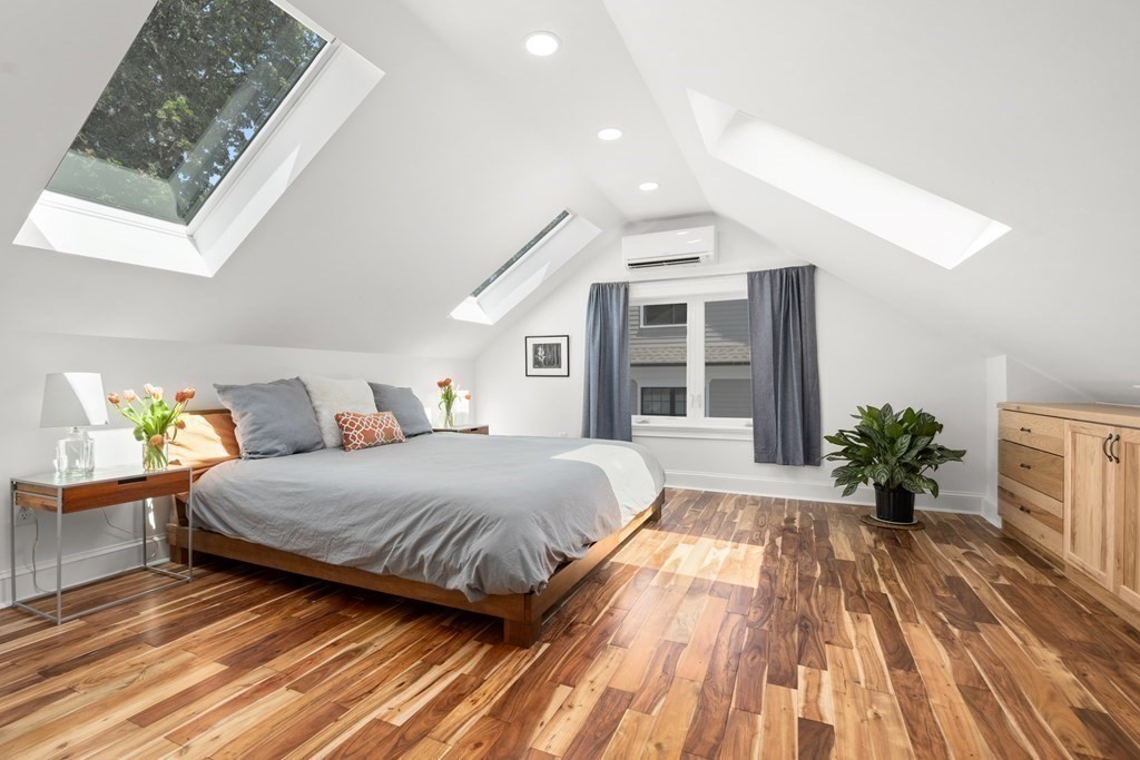 52 Arborough Road Boston, MA 02131 - Photo 7 of 35 a spacious bedroom with a large bed and a potted plant