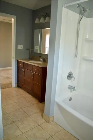 a bathroom with a bathtub sink and mirror