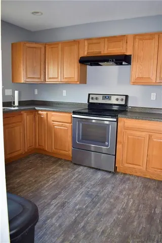 a kitchen with granite countertop a stove and a sink
