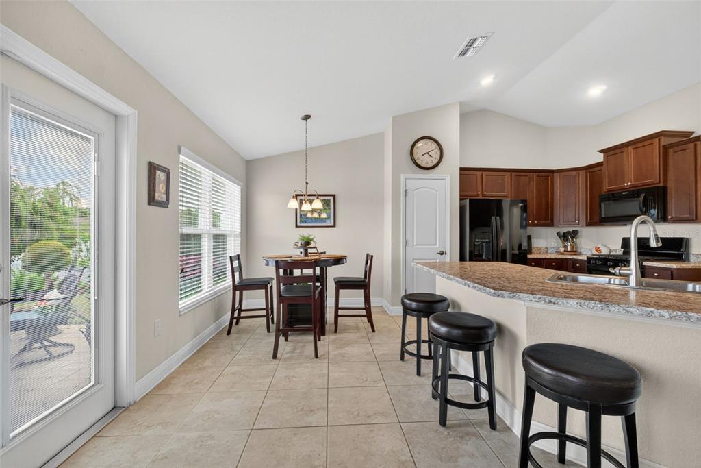 2429 Twin Lake View Road Winter Haven, FL 33881 - Photo 22 of 37 a kitchen with stainless steel appliances granite countertop a refrigerator and a stove top oven