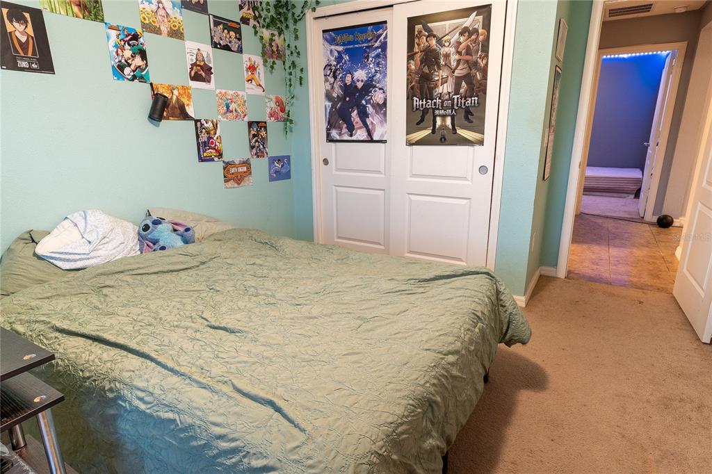 4563 Orchard Grove Road St. Cloud, FL 34772 - Photo 51 of 51 a bedroom with a bed and wall painting on the wall