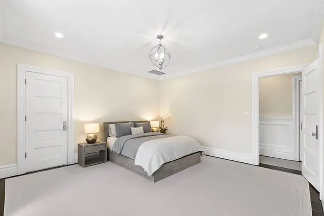 a spacious bedroom with a bed and cabinets