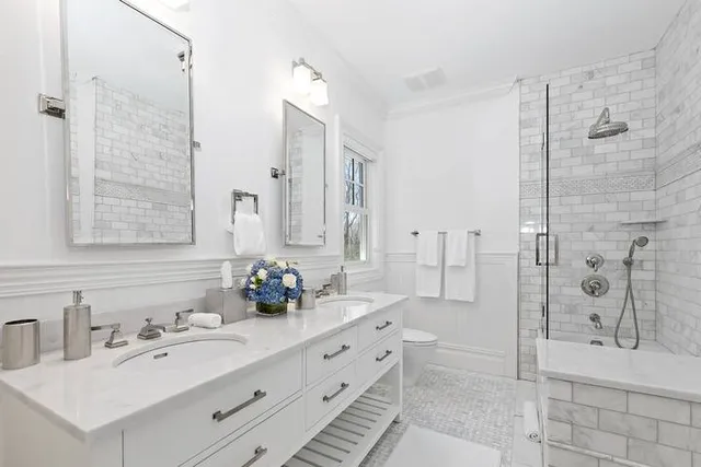 a bathroom with a double vanity sink mirror double shower and bathtub
