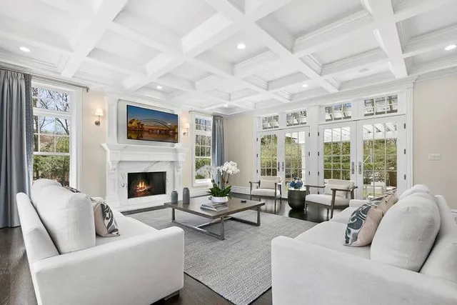 a living room with furniture large window and a fireplace