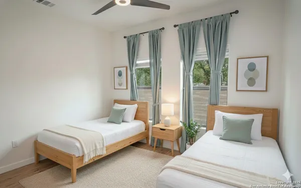 a bedroom with a bed and a large window