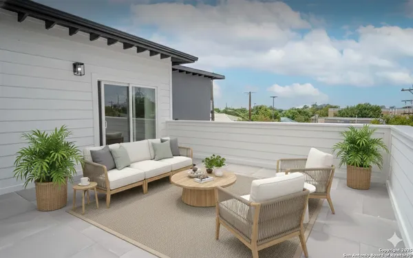 a view of a patio with couches and potted plants