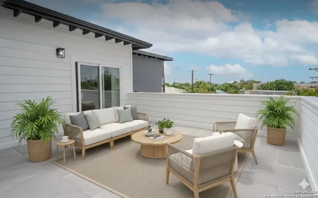 a view of a patio with couches and potted plants
