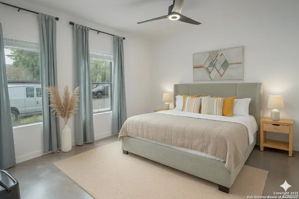 a spacious bedroom with a bed and glass door