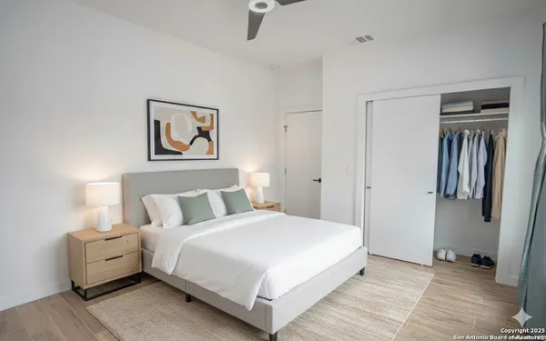 a bedroom with a bed and a wall painting