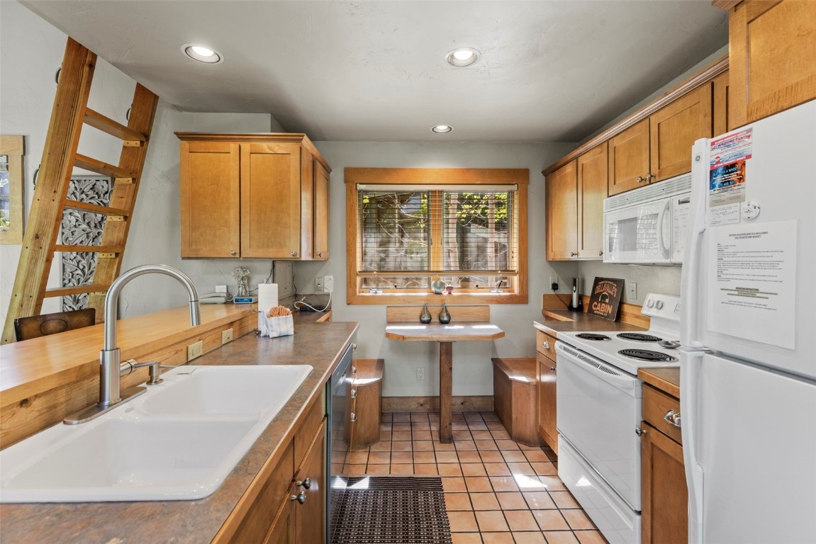 12 Big Boulder Court, Unit 13 Keystone, CO 80435 - Photo 12 of 35 a kitchen with a sink stove and cabinets